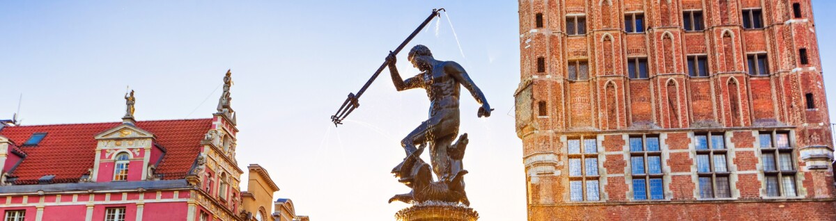 Poland, Gdansk, Famous Neptune fountain at sunset. Popular tourist attraction and travel destination in Europe